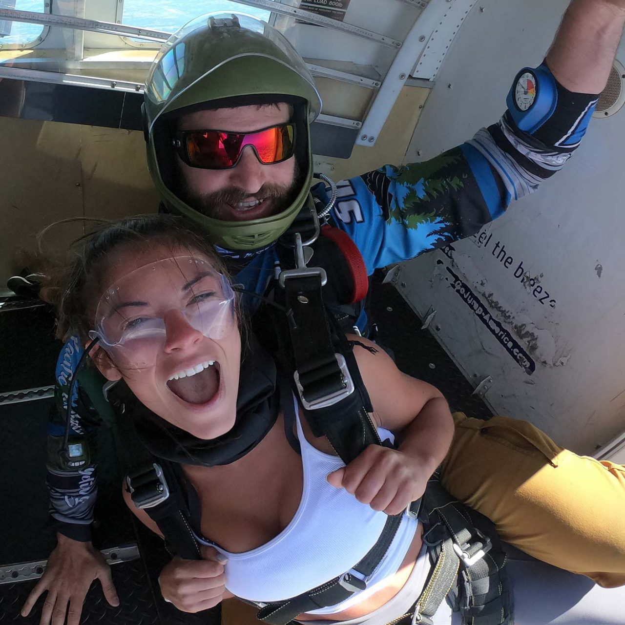 Smiling female tandem student and instructor in doorway of aircraft above Skydive the Volcano in Oregon